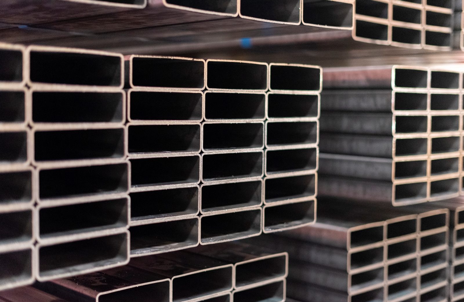 Stacked rectangular steel tubes showcasing the precision and quality of Heidtman Steel’s tubing process.